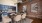 a kitchen with a brick wall and a table with chairs