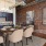 a kitchen with a brick wall and a table with chairs