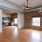a large empty room with a brick wall