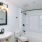 a bathroom with a tub sink and toilet